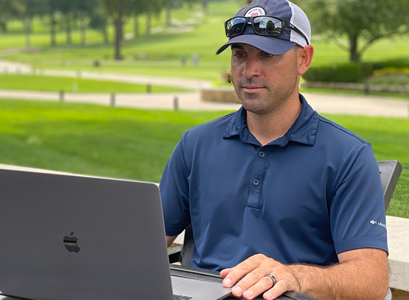 Man sitting outdoors and using a laptop