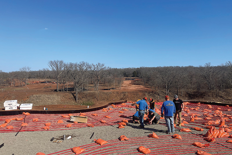 Workers outside at Karsten installing hydronic tubing