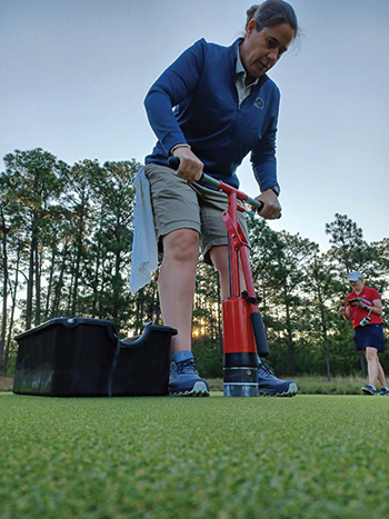 Jill Seymour on a golf course cutting cups