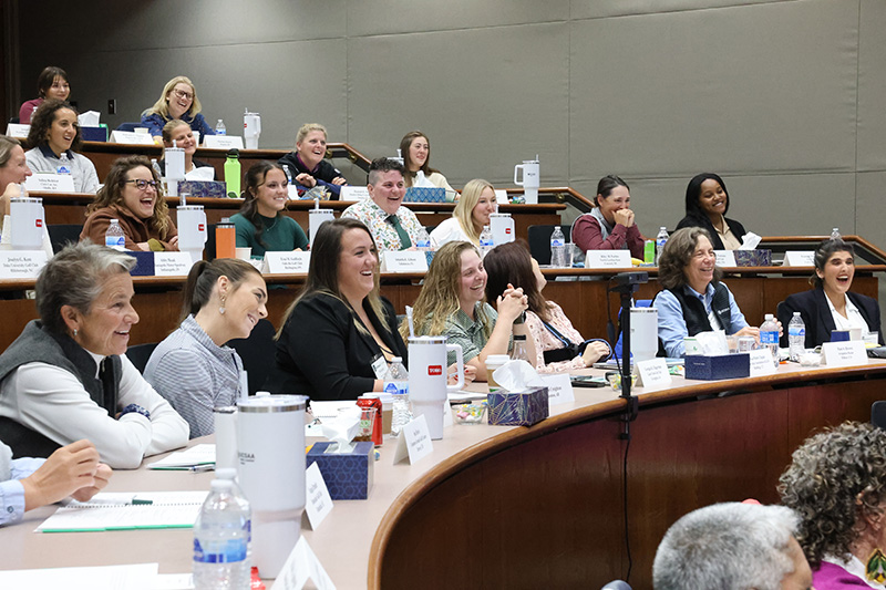 Women actively listening in an auditorium