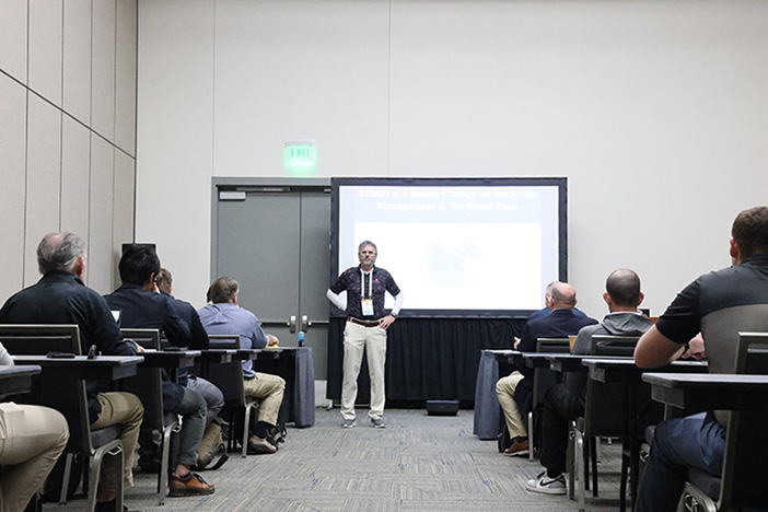 Man presenting in front of a seminar