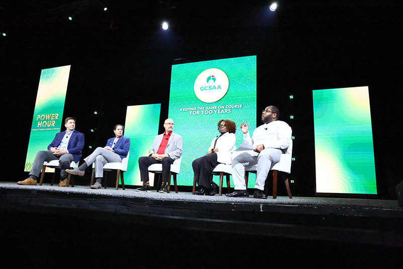 panelists seated on a stage