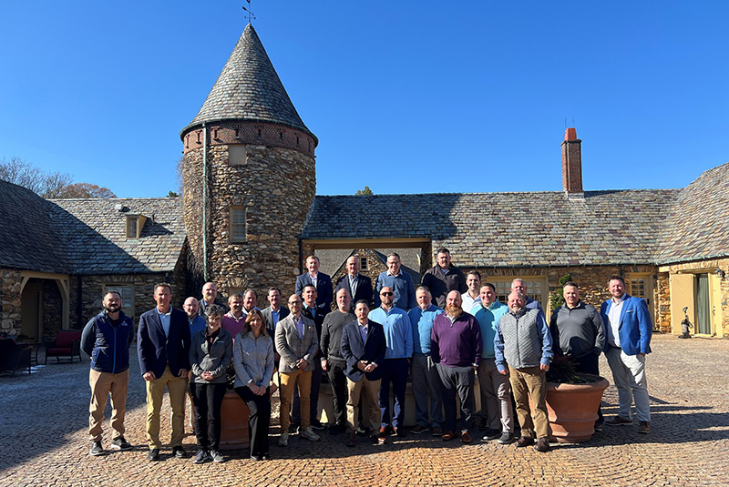 Attendees at the Syngenta Business Institute standing in an outdoor courtyard