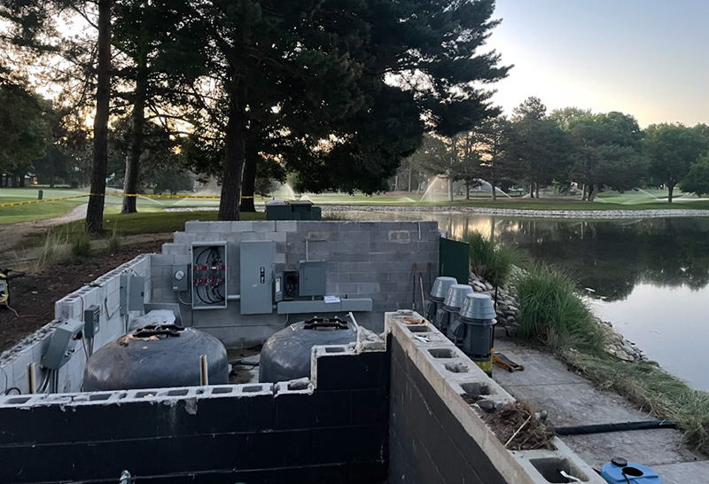 Damaged pump house next to a pond