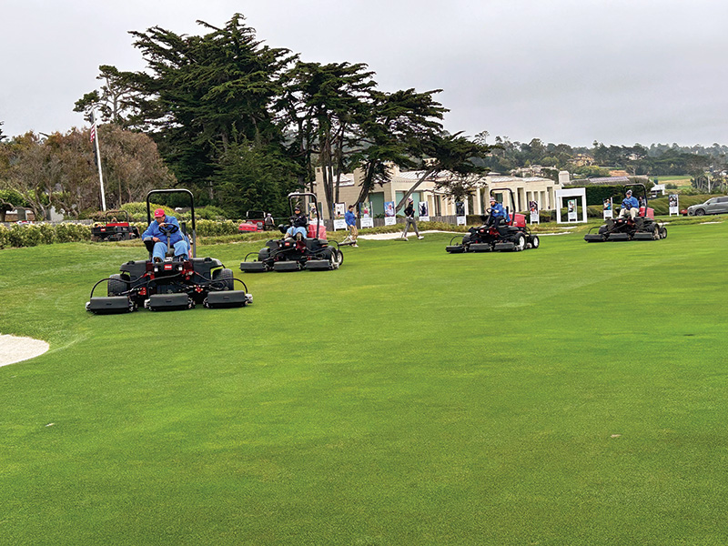 Volunteers mowing a fairway