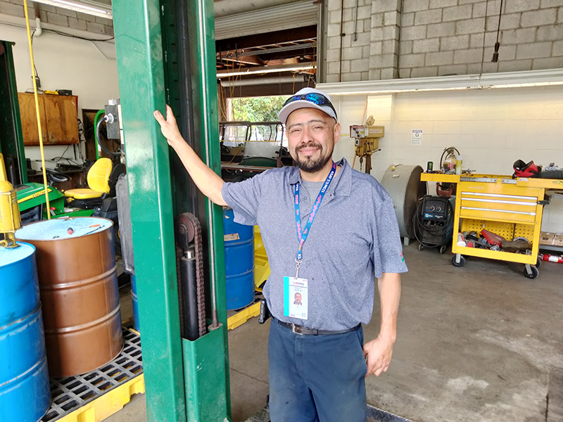 Humberto Sanchez Jr. in the mechanic shop at the Los Angeles Country Club during the 2023 U.S. Open Golf Championship