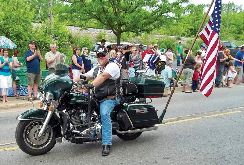 McCall on a motorcycle at a parade