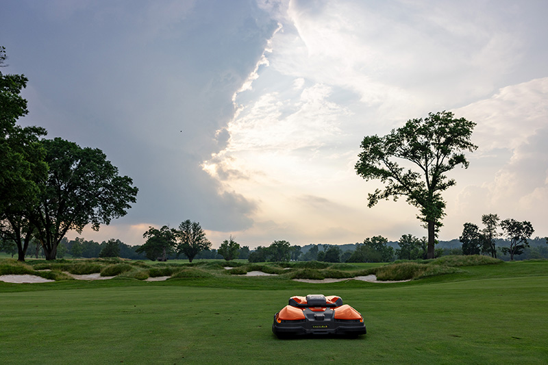 orange and black Husqvarna autonomous mower
