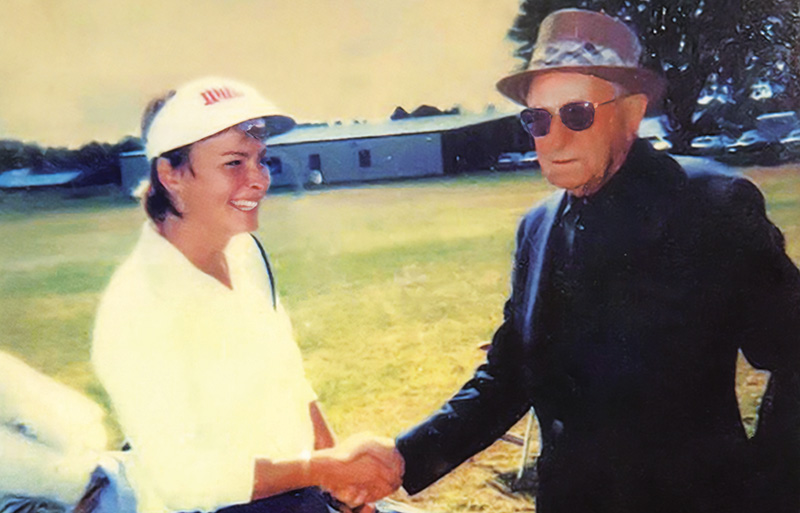 Vintage photograph of a young Dottie Pepper on the left, shaking hands with George Pulver, right